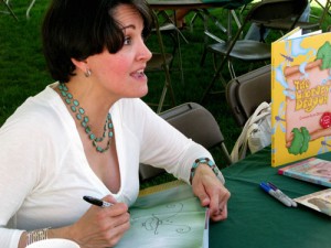 Carmen Deedy autographing a copy of her Library Dragon book.